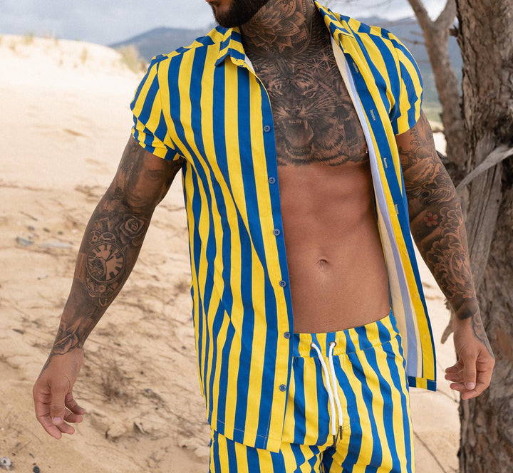 Men Printed Shirts in blue and yellow stripes, perfect for casual summer wear at the beach.