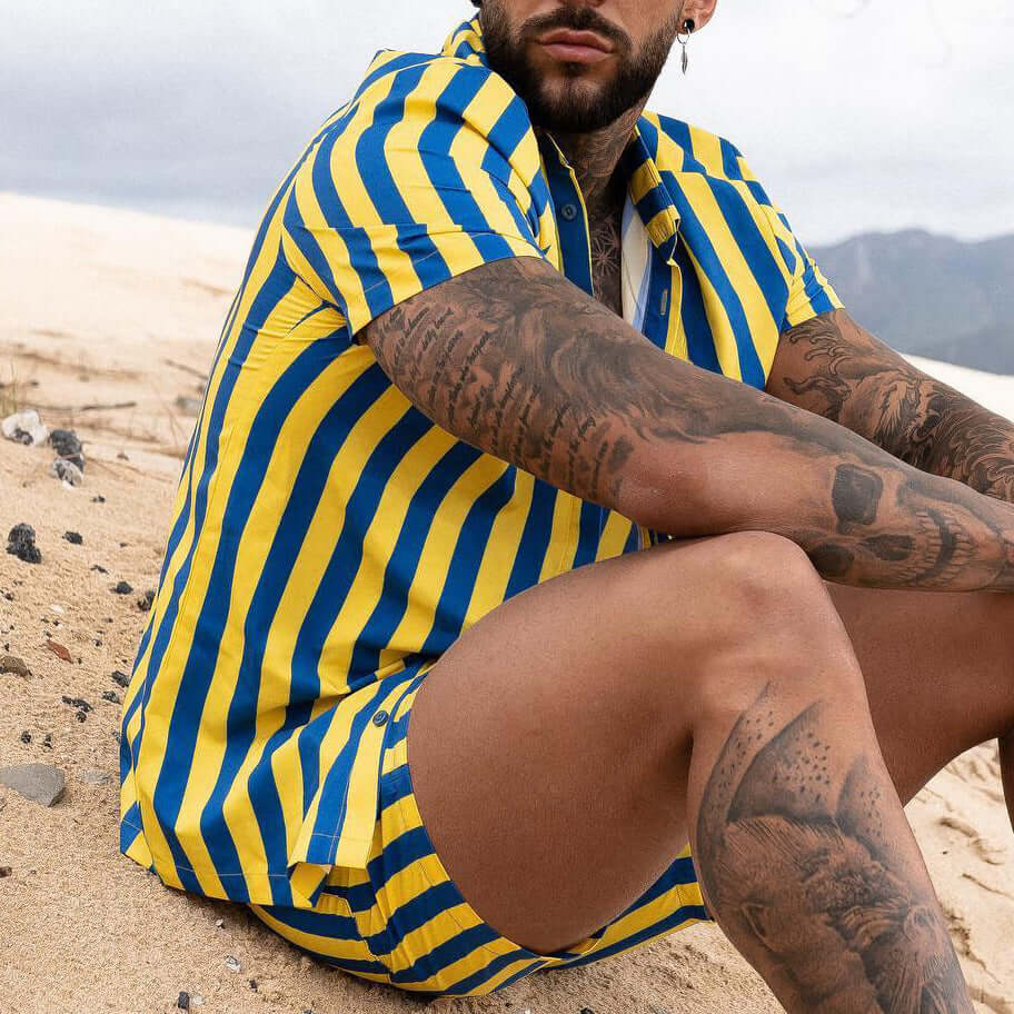 Men Printed Shirts in bold blue and yellow stripes, perfect for casual summer wear on the beach.