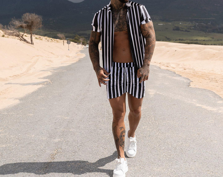 Men Printed Shirts casual summer wear with striped pattern and short sleeves walking on the road in the desert.